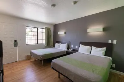 a hotel room with two beds and a window at Studio 6-Barstow, CA in Barstow