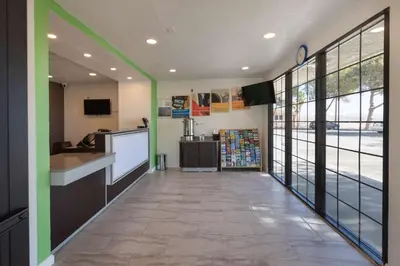 a hallway of a office with green and white walls at Studio 6-Barstow, CA in Barstow