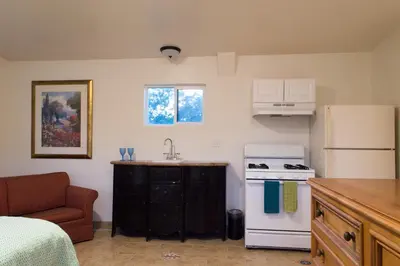 a kitchen with a sink and a stove and a refrigerator at Casa Del Sol in Carpinteria