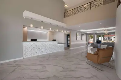 a lobby with a reception desk and a waiting room at SureStay Plus Hotel by Best Western Upland - Ontario North in Upland