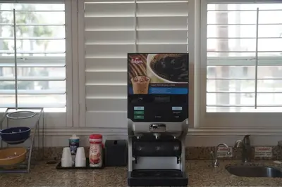 a coffee machine sitting on a counter in a kitchen at Harbor Inn & Suites in Anaheim