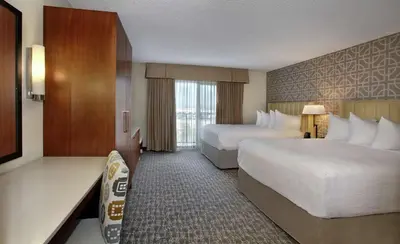 a hotel room with two beds and a window at Embassy Suites by Hilton Anaheim North in Anaheim