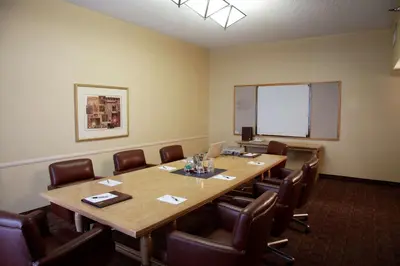 a conference room with a large wooden table and chairs at Embassy Suites by Hilton Anaheim North in Anaheim