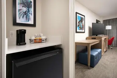 a hotel room with a desk and a room at Hampton Inn & Suites Anaheim Garden Grove in Anaheim
