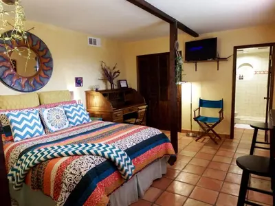 a bedroom with a bed and a desk and a chair at Ocean View Casita in Los Angeles