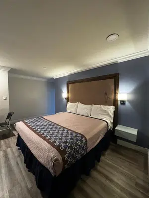 a hotel room with a large bed in it at Friendship Motor Inn in Los Angeles