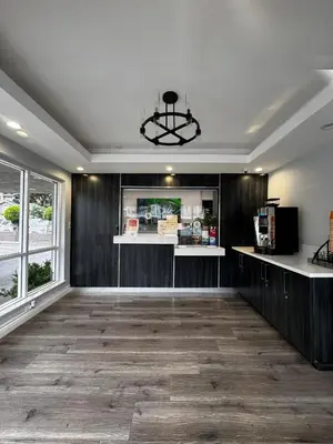a large room with a kitchen and a dining room at Friendship Motor Inn in Los Angeles