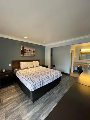 a bedroom with a large bed with a white bedspread at La Casa Inn in Pasadena