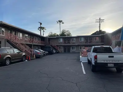 a parking lot with a truck parked in front of a building at La Casa Inn in Pasadena