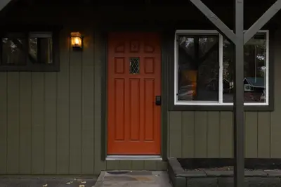 an orange door on the side of a house at The Burgundy in Big Bear Lake