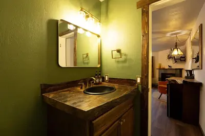 a bathroom with a sink and a mirror at The Burgundy in Big Bear Lake