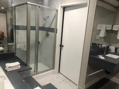 a bathroom with a shower and a sink at Economy Inn near Ontario Airport - Chino in Ontario
