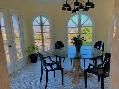 a dining room with a glass table and chairs at SpanishFairytale4bd3ba in San Pedro
