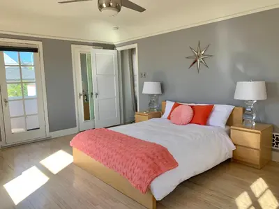 a bedroom with a large bed with red pillows at SpanishFairytale4bd3ba in San Pedro