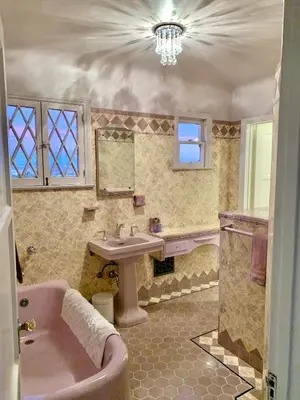 a bathroom with a pink tub and a sink at SpanishFairytale4bd3ba in San Pedro