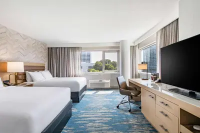 a hotel room with two beds and a flat screen tv at DoubleTree by Hilton LAX - El Segundo in El Segundo