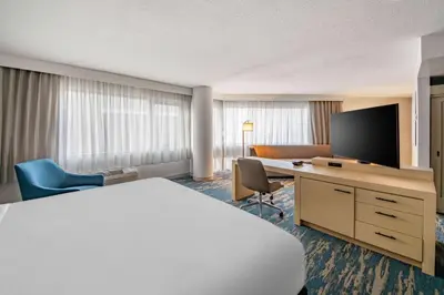 a hotel room with a bed and a desk with a tv at DoubleTree by Hilton LAX - El Segundo in El Segundo