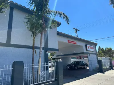 a car parked in front of a mobil gas station at Sahara Inn - Los Angeles in Los Angeles