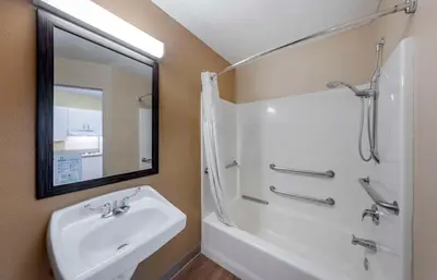 a bathroom with a sink and a tub and a mirror at Extended Stay America Suites - Orange County - Katella Ave in Orange