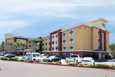 a hotel building with cars parked in a parking lot at Extended Stay America Suites - Orange County - Katella Ave in Orange