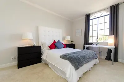 a bedroom with a large bed and a window at Designer Penthouse 2 Bedroom with Balcony Beverly Hills Adjacent in Los Angeles