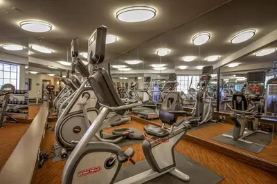 a gym with several treadmills and elliptical machines at Designer Penthouse 2 Bedroom with Balcony Beverly Hills Adjacent in Los Angeles
