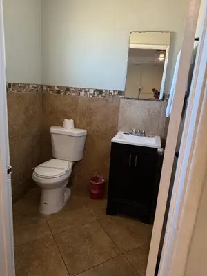 a bathroom with a toilet and a sink at Apple Valley Motel in Apple Valley
