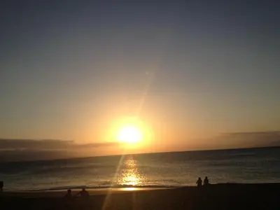 a group of people on the beach at sunset at Bartlett Motel in Lomita