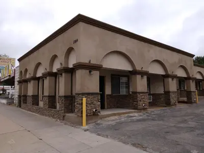 a building with arches on the side of a street at Bartlett Motel in Lomita