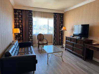 a living room with a couch and a flat screen tv at Garden Suite Hotel and Resort in Los Angeles