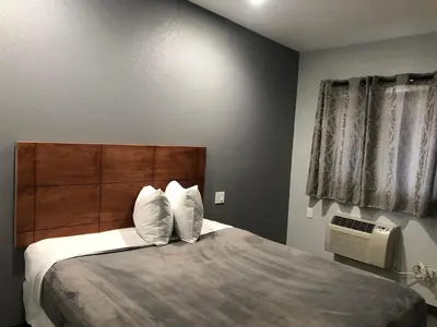 a bedroom with a bed with two pillows on it at New Casa Motel Los Angeles in Los Angeles