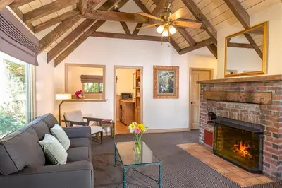 a living room with a couch and a fireplace at The Pierpont Inn in Ventura