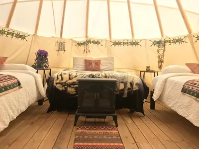 a bedroom with two beds in a tent at Olancha RV Park and Motel in Olancha