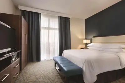 a hotel room with a bed and a large window at Embassy Suites by Hilton Brea - North Orange County in Brea