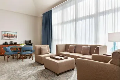 a living room with a couch and chairs and a table at Embassy Suites by Hilton Brea - North Orange County in Brea