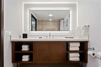a bathroom with a sink and a mirror at Embassy Suites by Hilton Anaheim South in Anaheim