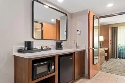 a bathroom with a sink and a mirror at Embassy Suites by Hilton Anaheim South in Anaheim