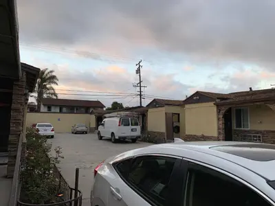 a white van parked in a parking lot at Apache Inn in Lynwood