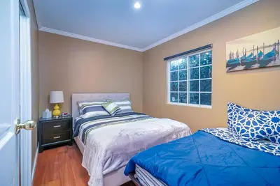 a bedroom with two beds and a window at Stylish 2 Bed & 2 Bath at the Heart of Hollywood with Free Parking - One Car only in Los Angeles