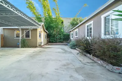 an empty driveway in front of a house at Stylish 2 Bed & 2 Bath at the Heart of Hollywood with Free Parking - One Car only in Los Angeles