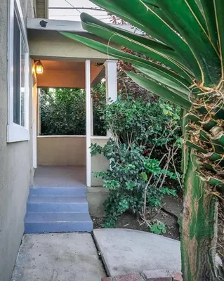 a porch of a house with stairs and plants at Stylish 2 Bed & 2 Bath at the Heart of Hollywood with Free Parking - One Car only in Los Angeles