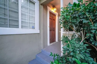 a door of a house with a bush next to it at Stylish 2 Bed & 2 Bath at the Heart of Hollywood with Free Parking - One Car only in Los Angeles