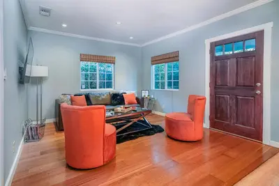 a living room with orange chairs and a table at Stylish 2 Bed & 2 Bath at the Heart of Hollywood with Free Parking - One Car only in Los Angeles