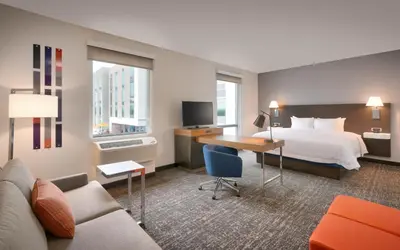 a hotel room with a bed and a desk at Hampton Inn & Suites Anaheim Resort Convention Center in Anaheim