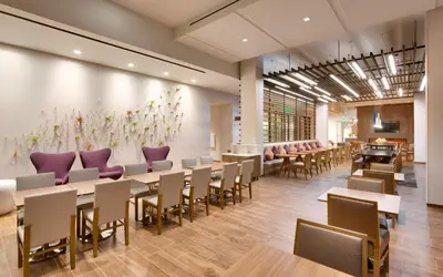 a dining room with tables and purple chairs at Hampton Inn & Suites Anaheim Resort Convention Center in Anaheim