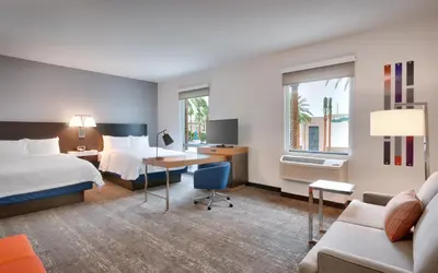 a hotel room with a bed and a desk at Hampton Inn & Suites Anaheim Resort Convention Center in Anaheim
