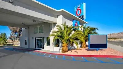 a sign in front of a gas station at Motel 6 Victorville in Victorville