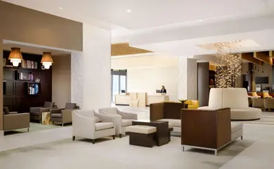 a lobby of a hotel with couches and chairs at Hyatt Place Pasadena in Pasadena