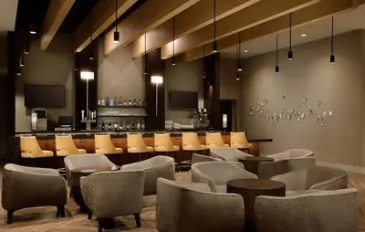 a restaurant with chairs and a bar in the background at Hyatt Place Pasadena in Pasadena