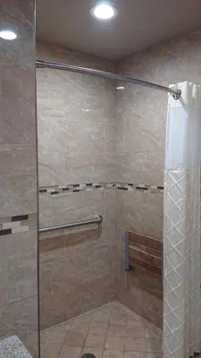 a shower with a glass door in a bathroom at Santa Ana Travel Inn in Santa Ana
